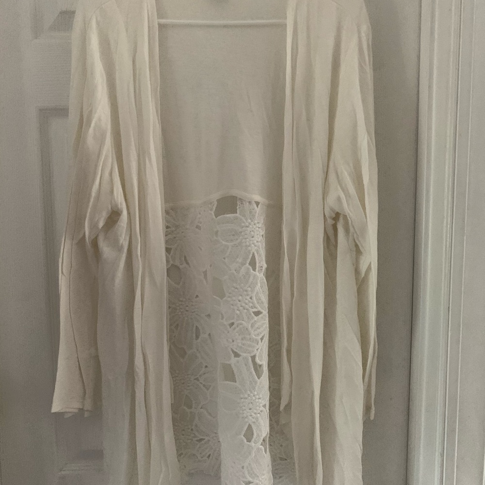 Sweater with open floral detail on the back.